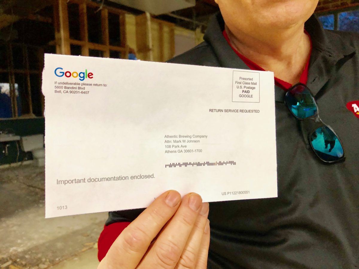 Mark holding google postcard